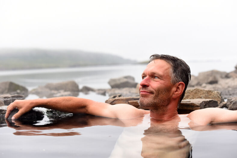 Man bathing in a natural hot spring.