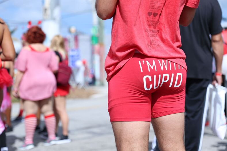 Man wearing red boxers that read "I'm with Cupid."