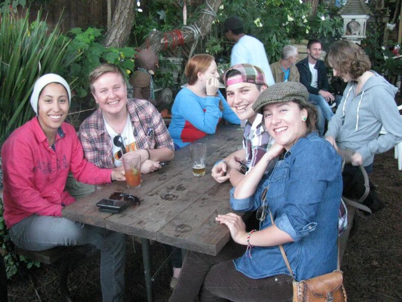 A group of friends enjoying drinks in an outdoor patio