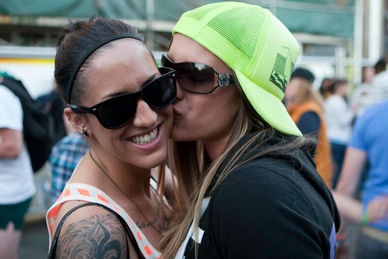 A girl kissing another girl on the cheek.