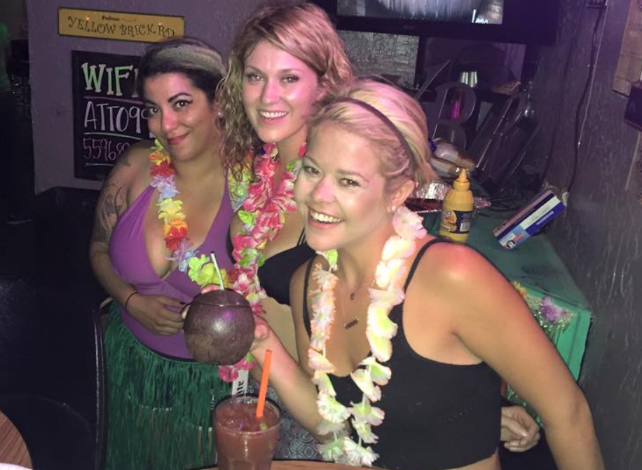 Three girls wearing flower leis.