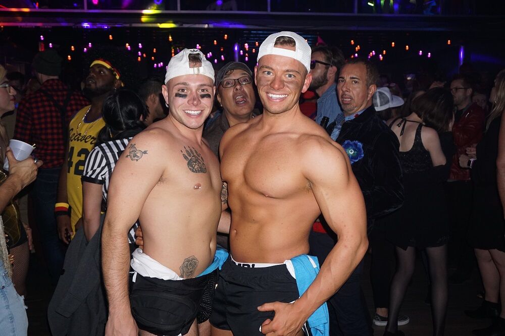 Two shirtless guys inside Angles nightclub in OKC.
