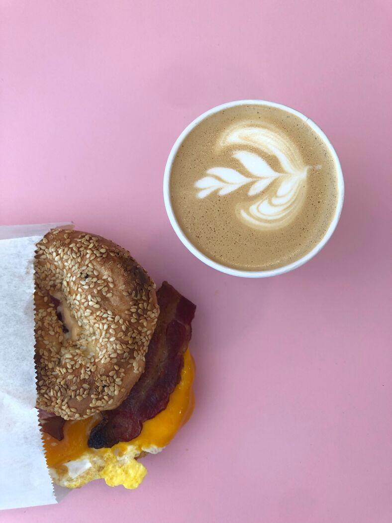  A freshly poured coffee with latte art and a scrumptious breakfast sandwich from Le Vieux Velo.
