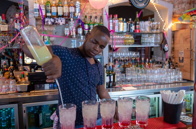 A bartender making drinks at Cafe Manhattan in Cape Town.