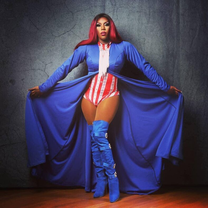 A drag queen in a red, white, and blue bedazzled outfit poses at the Urban Cowboy in Dallas. 