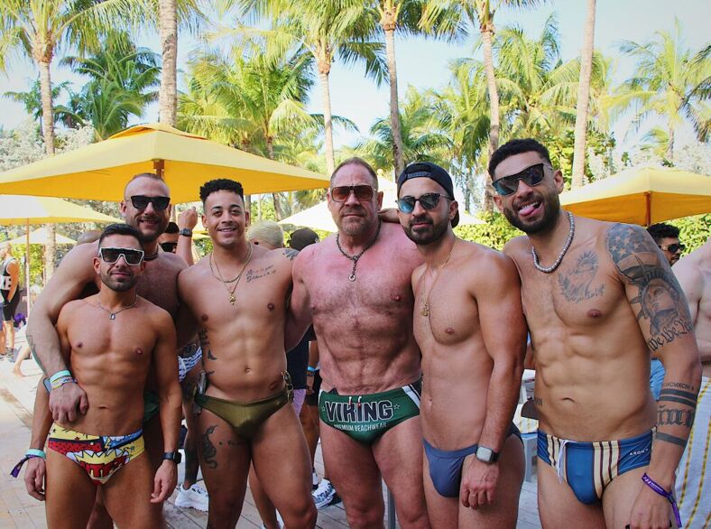 Some sexy speedo-clad boys posing poolside at the Elevation party.