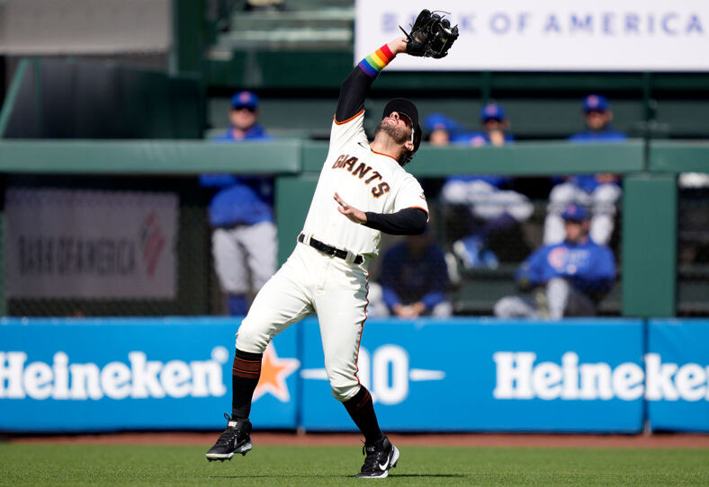 Mike Tauchman #29 of the San Francisco Giants catches a fly ball off the bat of Joc Pederson #24 of the Chicago Cubs during the top of the first inning at Oracle Park on June 05, 2021 in San Francisco, California. The Giants are wearing logos with rainbow colors on their hats and right sleeves that symbolize the LGBT community on San Francisco Pride Day.