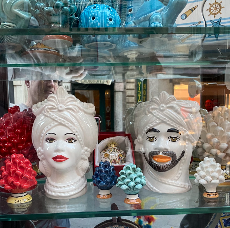 Two painted porcelain heads, a common good in Taormina.