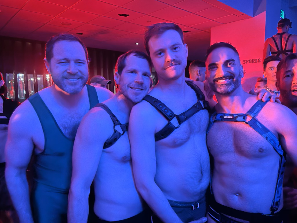 Four guys in leather apparel posing for the camera.