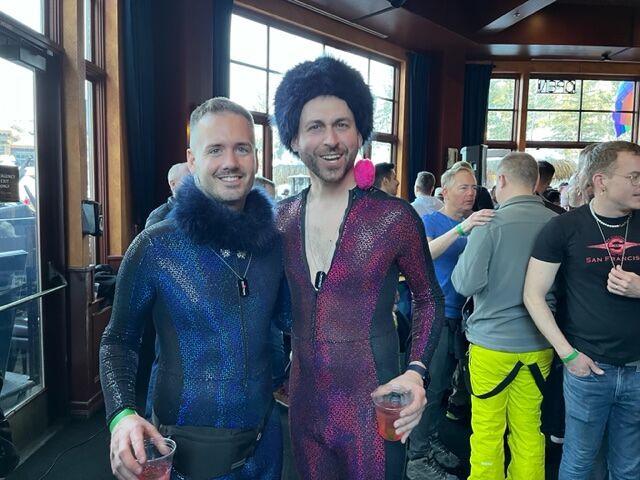Two men in skin tight skiing costumes posing for the camera.