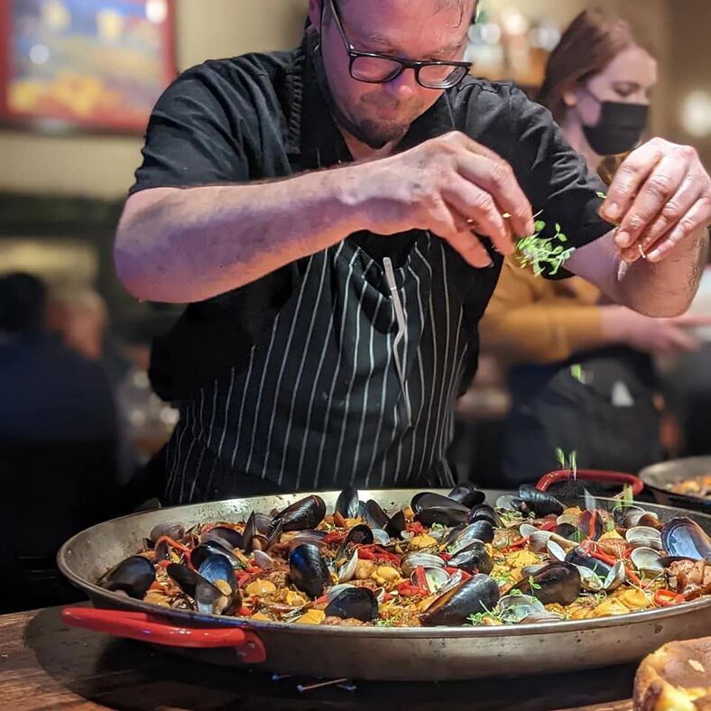 A chef prepares food at Urdaneta.