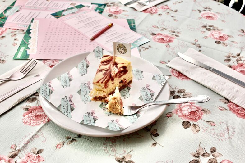 Cheesecake on a table with floral table cloth.