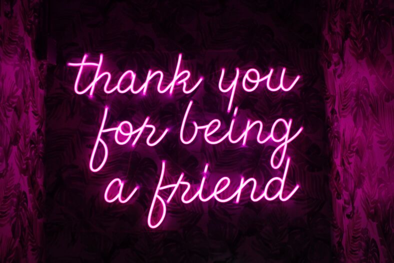 A neon sign that reads "thank you for being a friend."