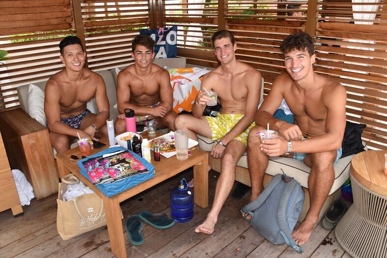 Four shirtless hunky men pose for the camera after attending the Honolulu Rainbow Film Fest.