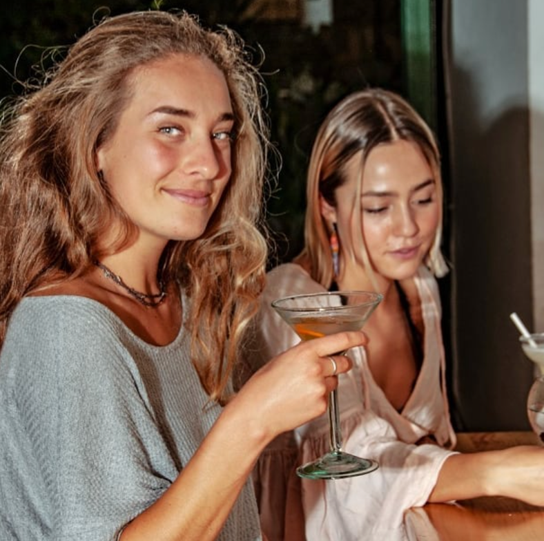 Two women enjoy cocktails at Raspados Barbara Barichara