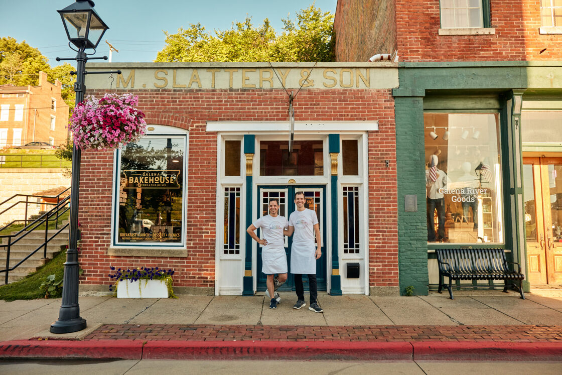 two men in aprons stand outside of a bakehouse in Galena, IL