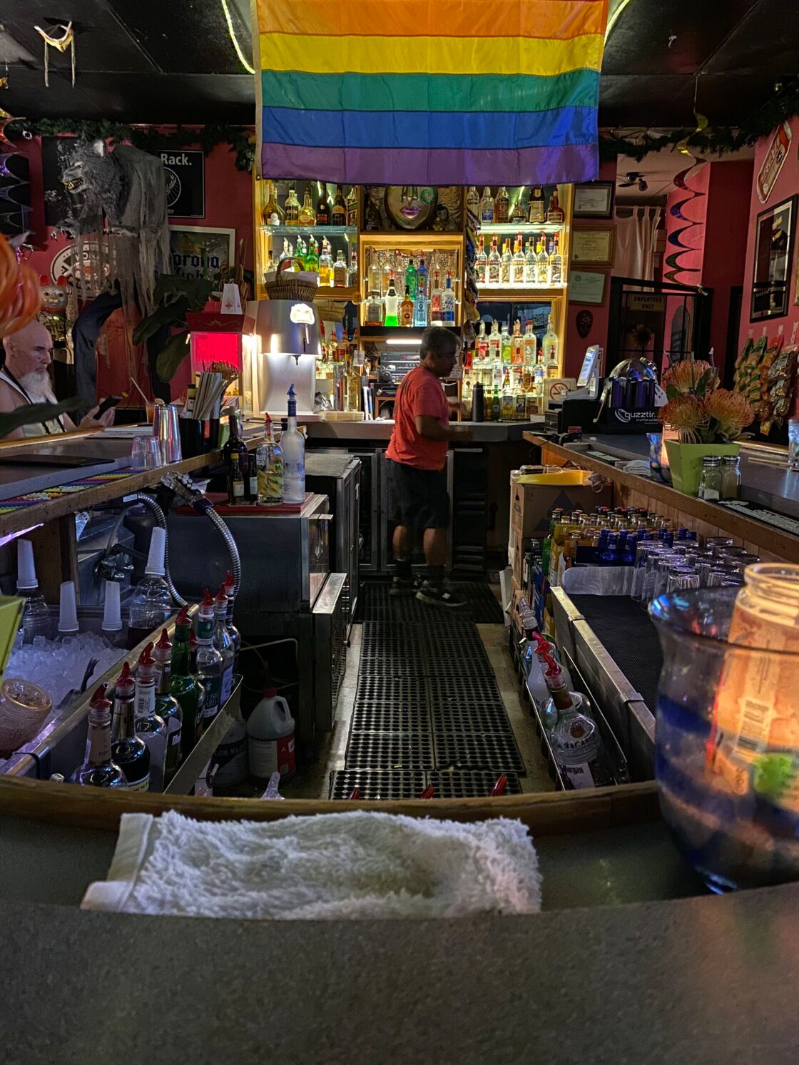 A bartender works diligently behind the bar.