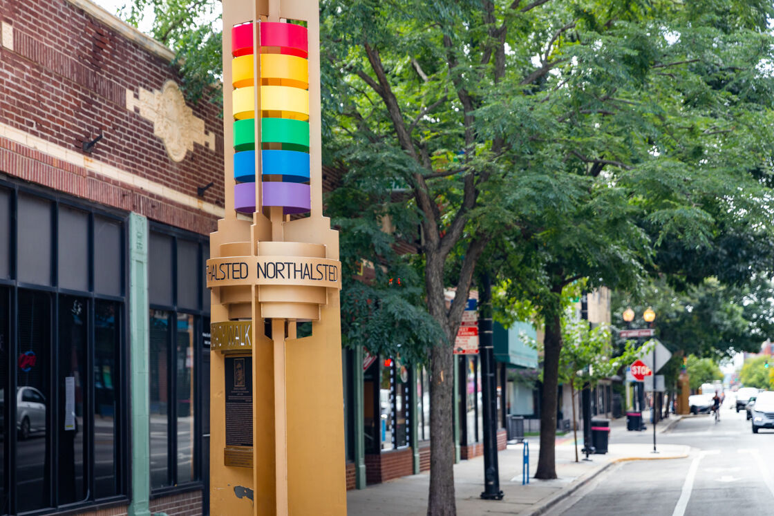 A close-up of a rainbow-coored Legacy Walk pillar in the Northalsted neighborhood of Chicago
