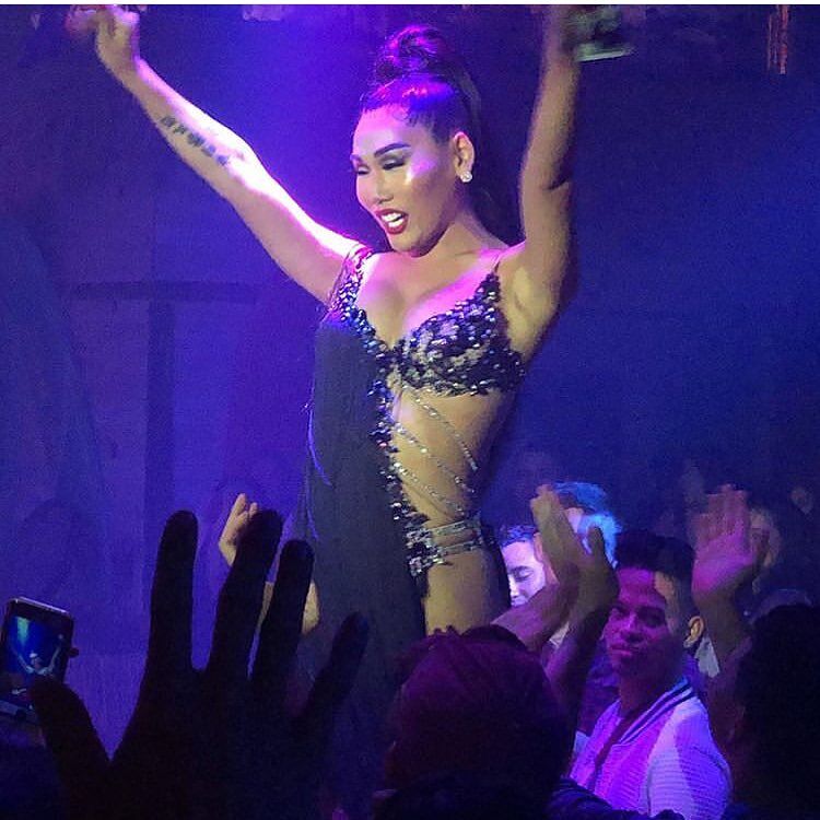 Drag performer dances on stage for the crowd.