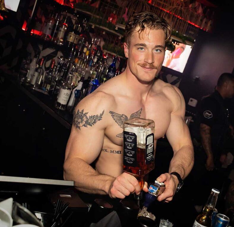 A shirtless bartender at Strut in Orange County