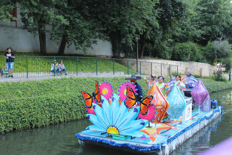 A river float with pastel colors and giant butterflies floats down the river