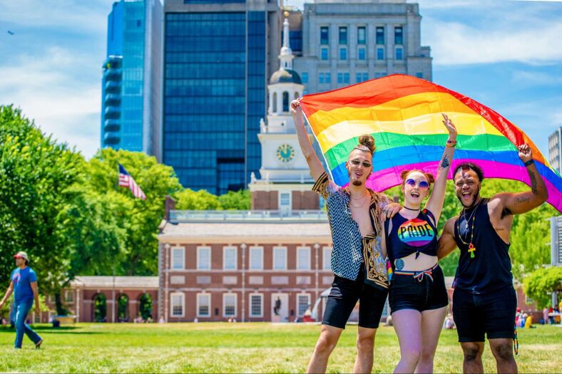 Three people celebrate Pride in Philadelphia