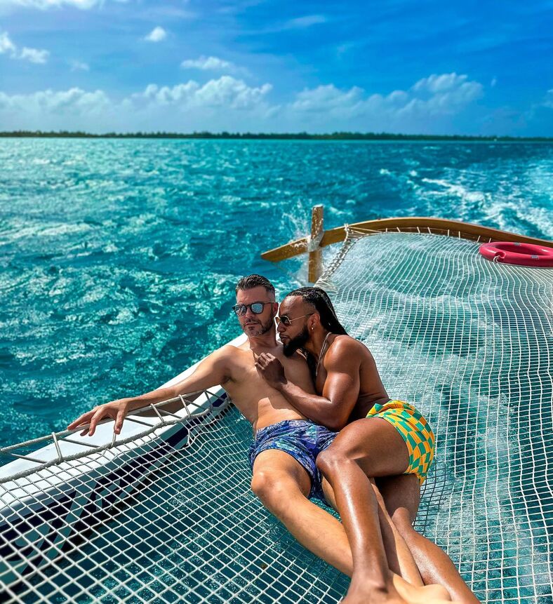 Emile and AJ on a lounging net on a boat.