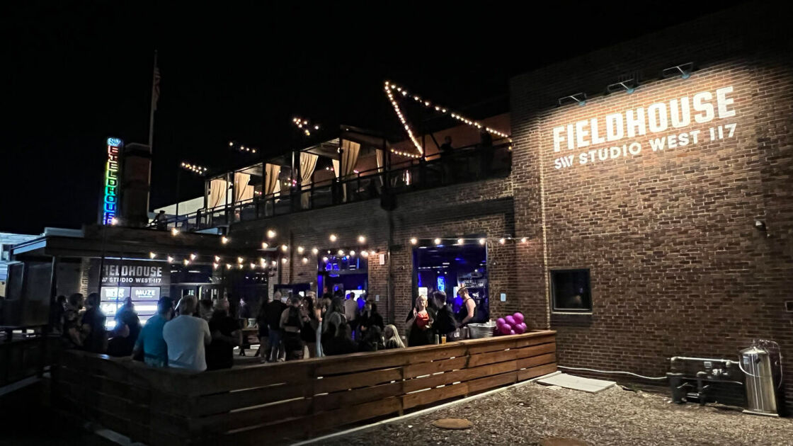 Outdoor patio of Fieldhouse at night, packed with people. Photo via Studio West 117