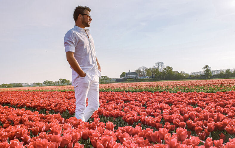 A man in a field of tulips