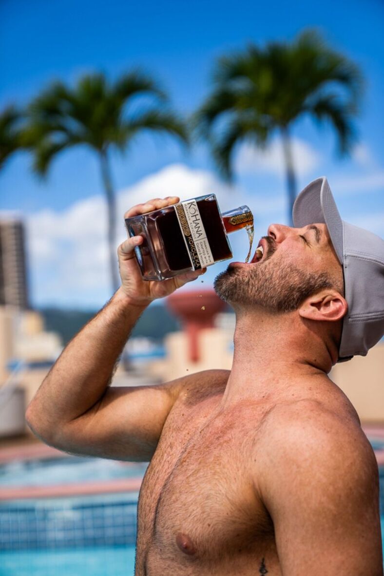 man drinks rum straight from the bottle.