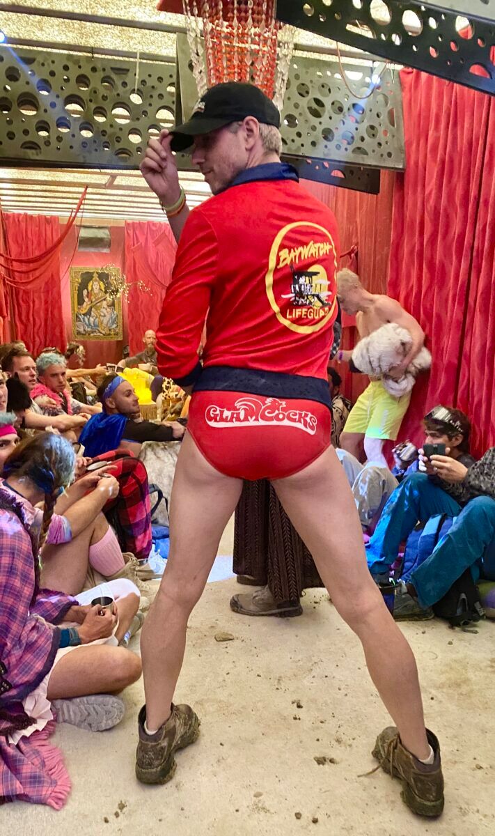 Veteran Glamcock BamBam sporting his speedo at an indoor beach party. 