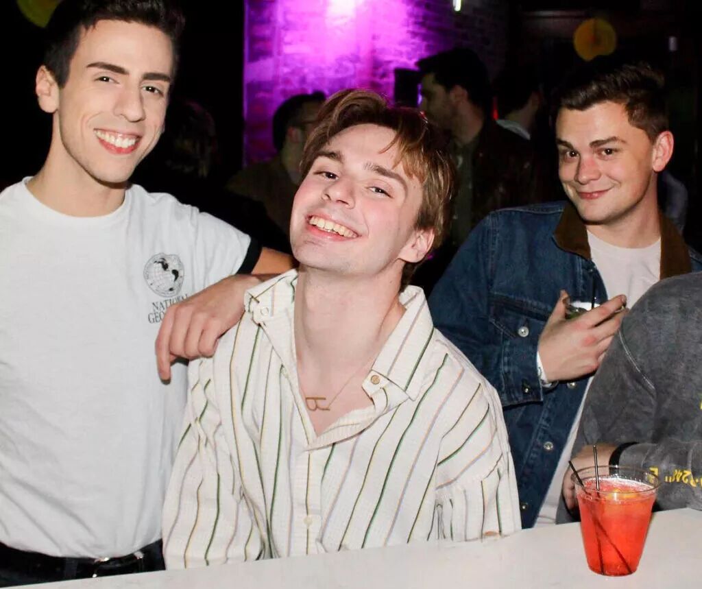 3 friends at a gay bar.