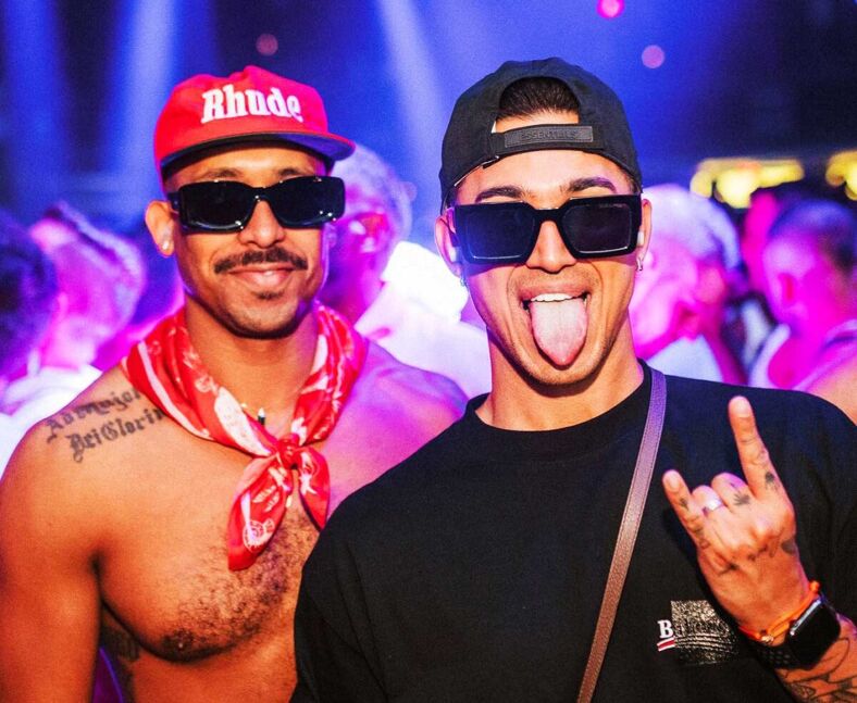 Two guys at a circuit party inside a nightclub in Miami.