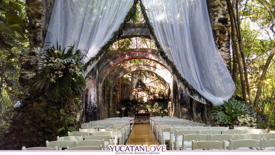 Jungle outdoor wedding venue. Draped in white linen