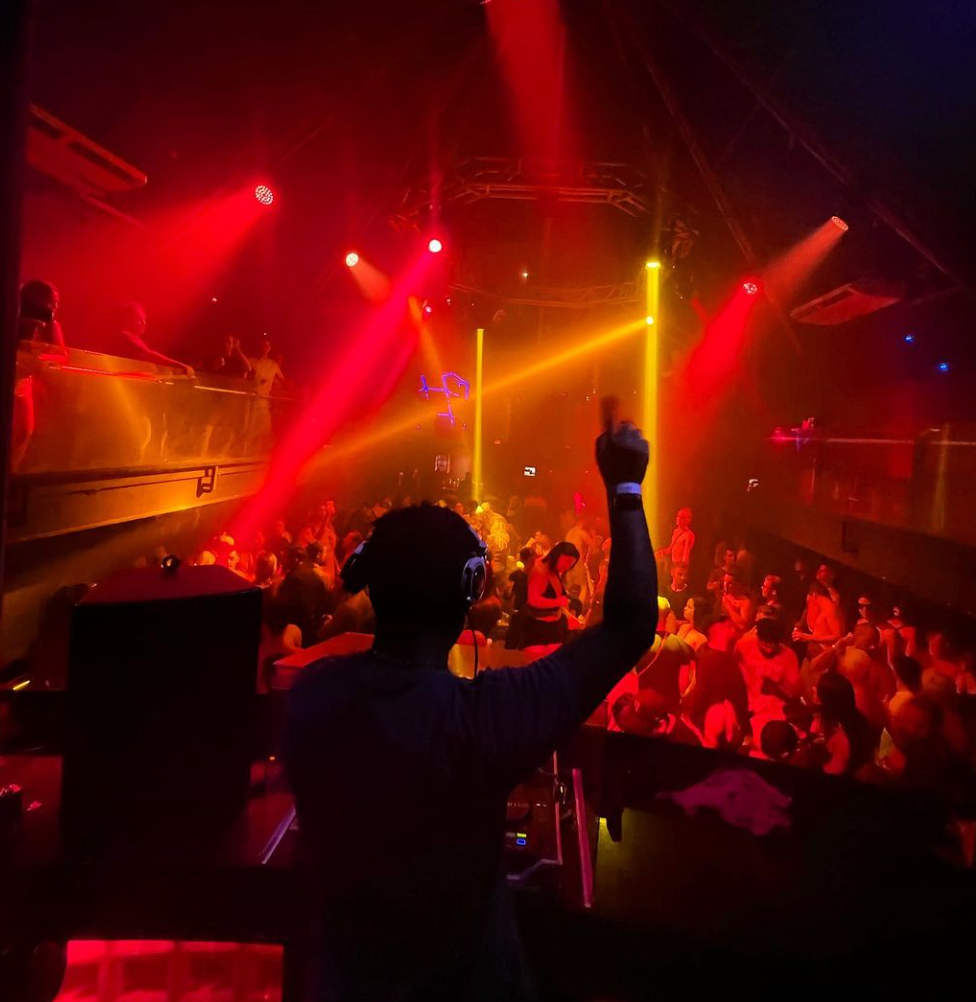 Lights stream out over a dancing crowd at a nightclub
