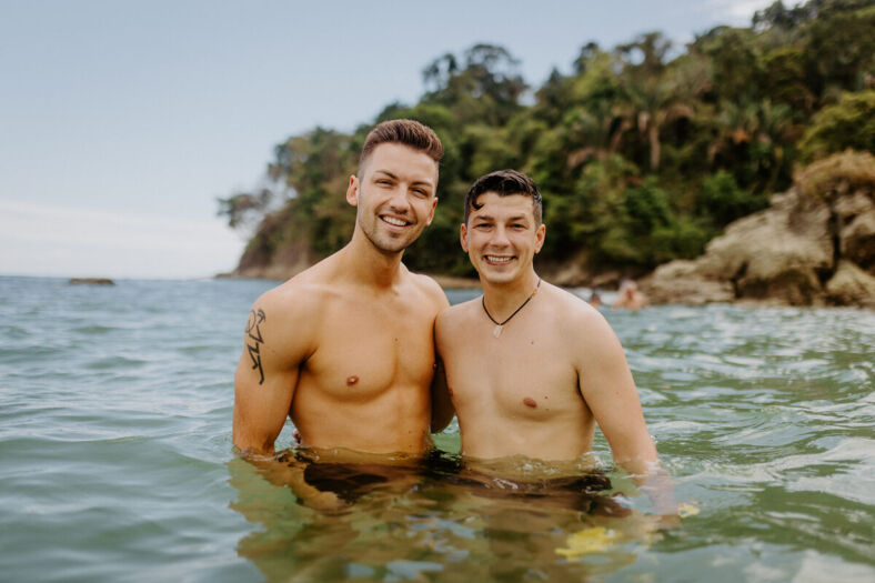 two men in the water at the beach