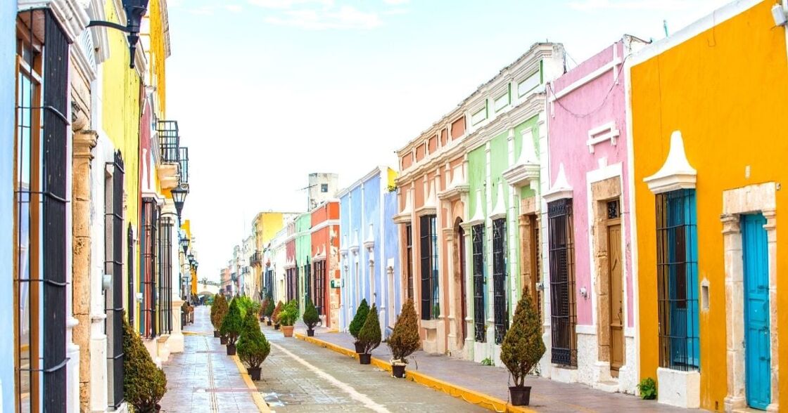 A colorful stretch of road. European/Caribbean style buildings all painted bright colors