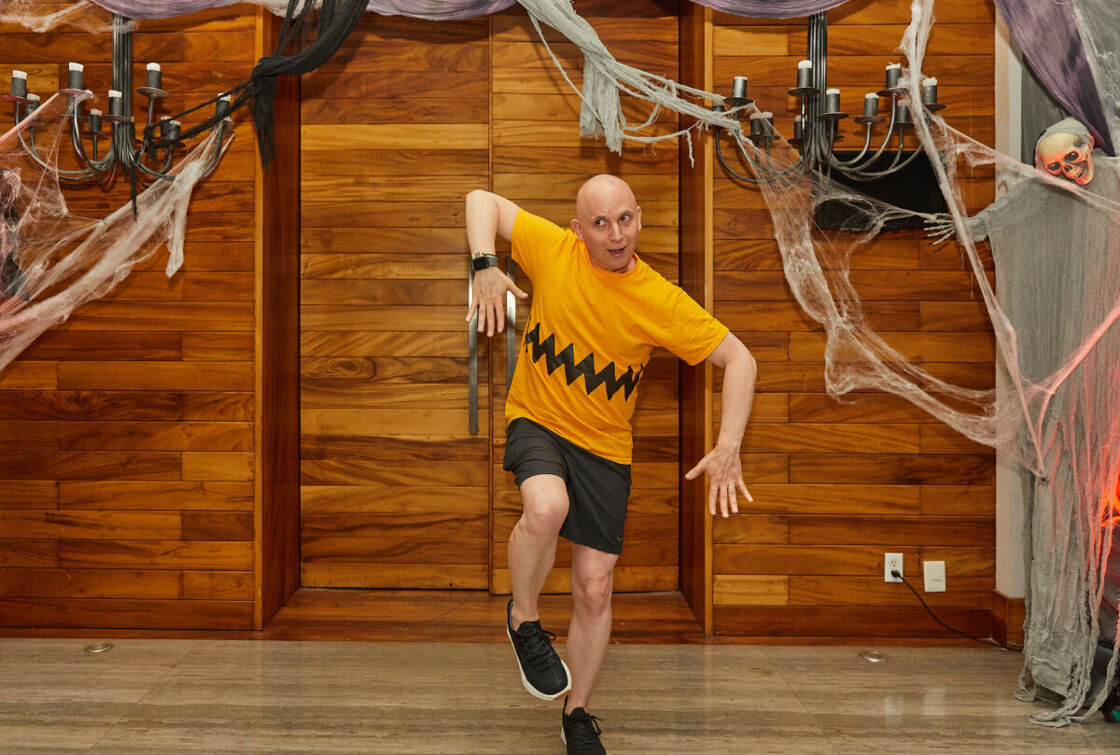 A guest dressed like Charlie Brown and VACAYA Halloween Party.