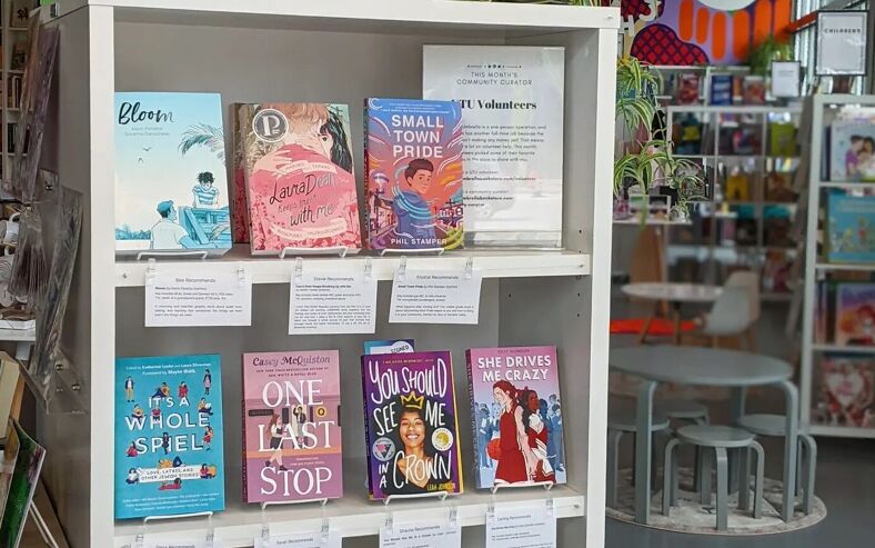 A close-up of LGBTQ+ books in Under the Umbrella Bookstore.