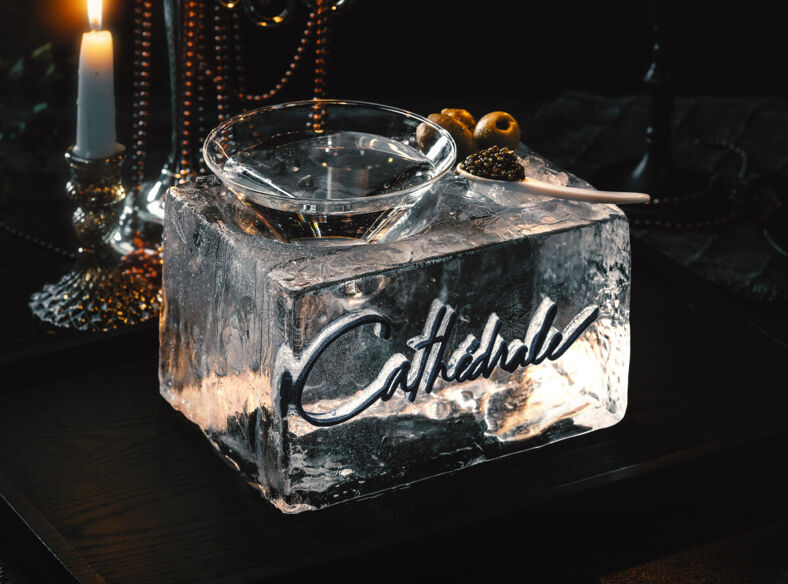 A craft cocktail served in a block of ice at Cathedrale