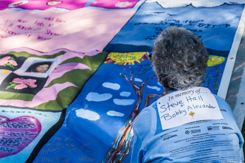 Unidentified woman viewing section of AIDS Quilt