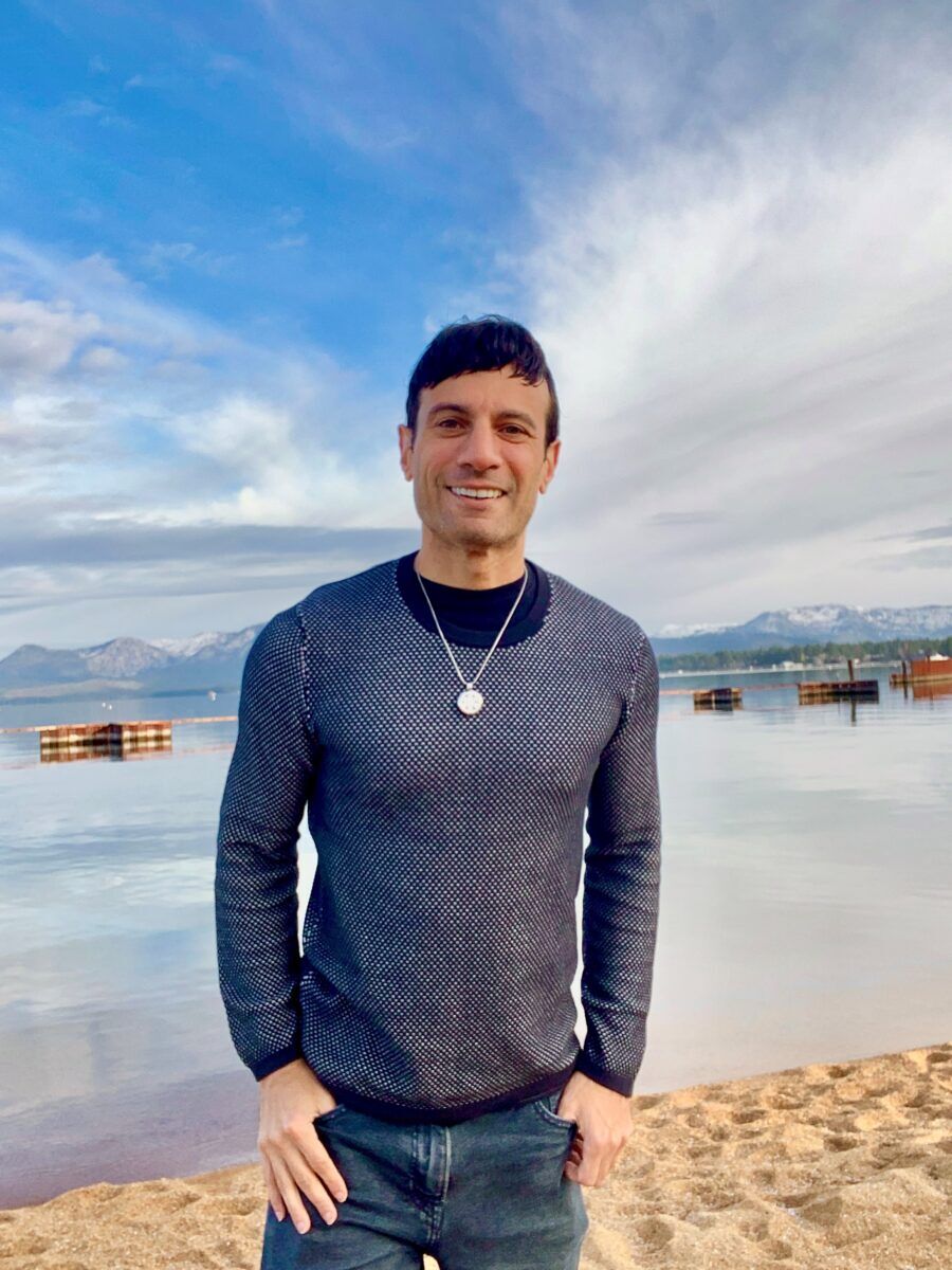 Joey Amato stands on the shore of Lake Tahoe