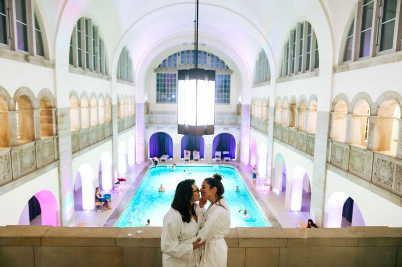 two women in bathrobes at a hotel pool