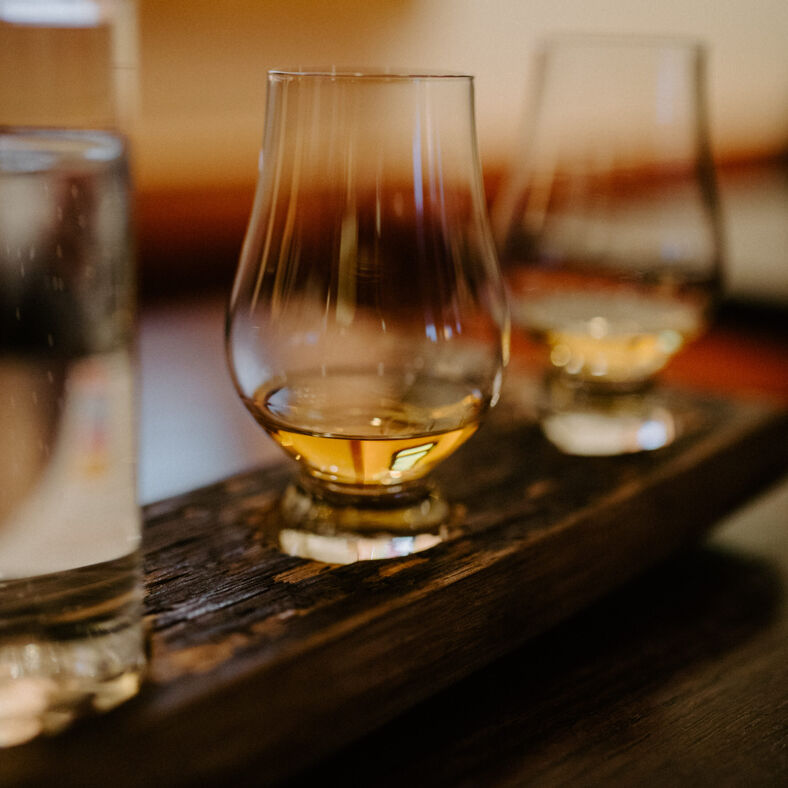 Glasses of Scottish whiskey on the bar.