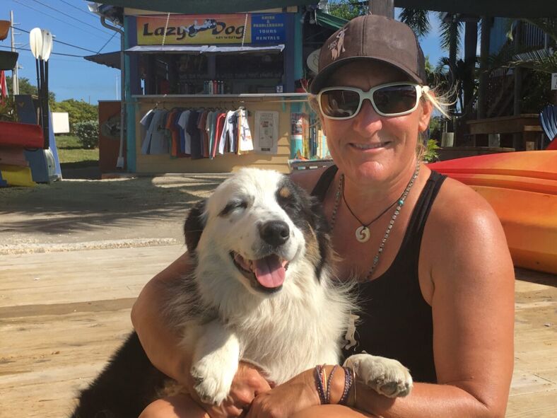 Sue Cooper and her dog, Jax, pose in front of Lazy Dog Adventures in Key West. 