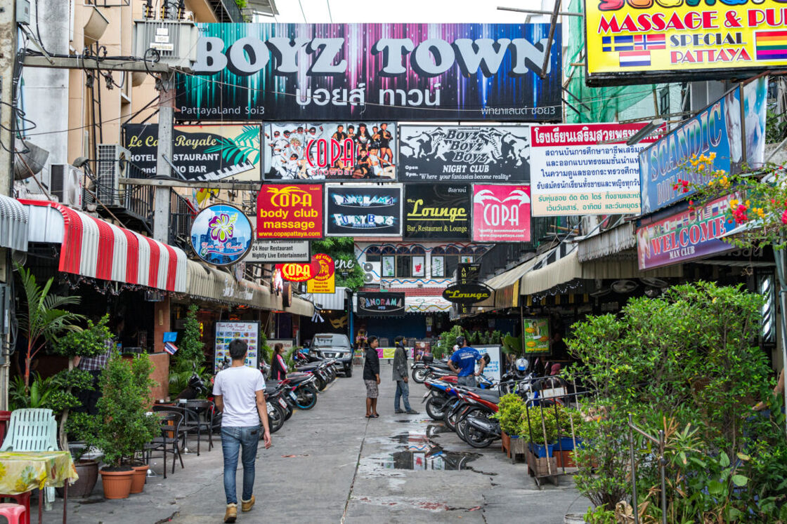 Signs of restaurants, salons, bars, and night clubs of Boyz Town (Boyztown), a gay nightlife area in Thailand, in the afternoon
