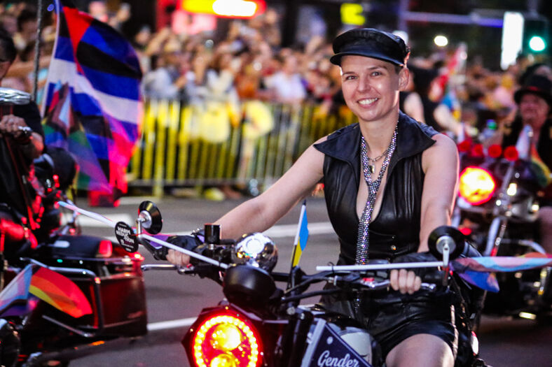 A lesbian sits astride her motorcycle as part of the Dykes on Bikes segment of the San Francisco Pride parade