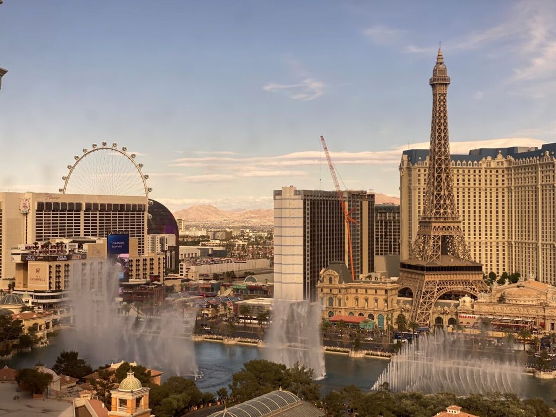 View of the Bellagio fountains with other Las Vegas landmarks in the distance.