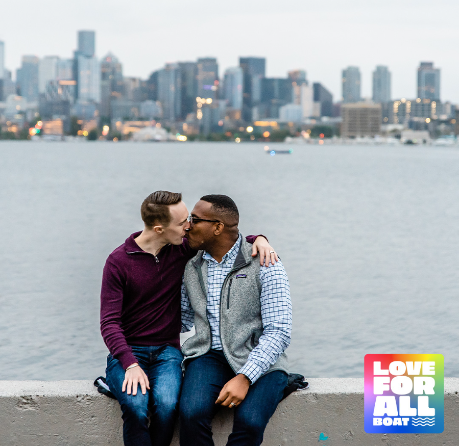 A gay couple kisses in Seattle before renewing their vows on the Love For All Boat