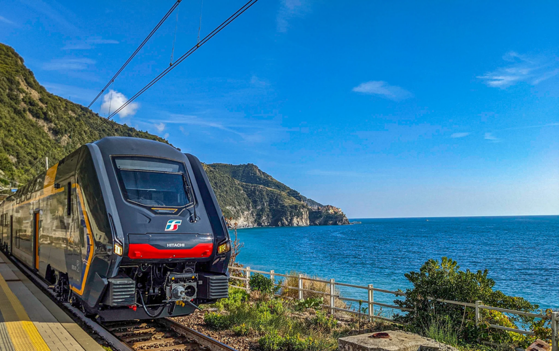 A train winds along the coastline of Cinque Terre